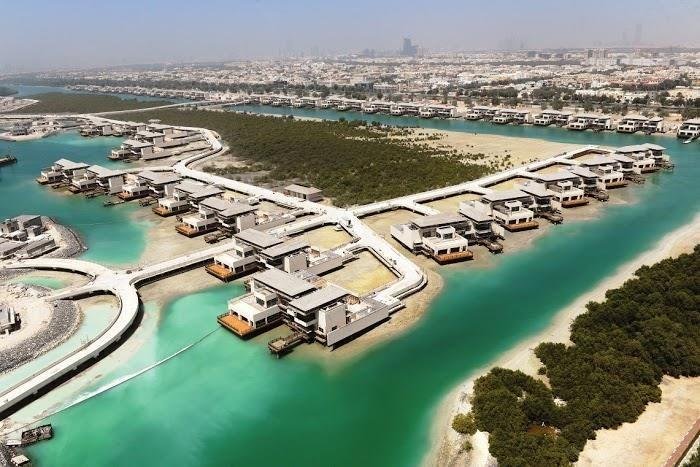 Panoramic aerial perspective of Al Gurm Abu Dhabi featuring luxury waterfront villas, protected mangrove forests, and exclusive eco-conscious island living.